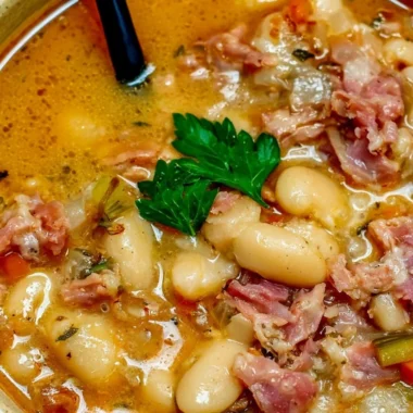 Crock Pot ham bone and bean soup in a bowl garnished with parsley