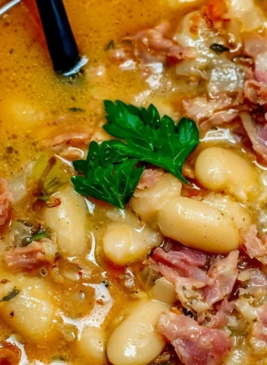 Crock Pot ham bone and bean soup in a bowl garnished with parsley