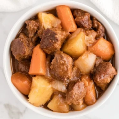Delicious Crockpot beef stew simmering with vegetables and tender meat.