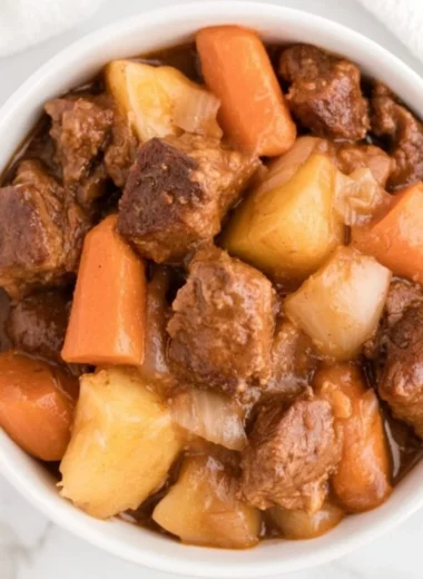 Delicious Crockpot beef stew simmering with vegetables and tender meat.
