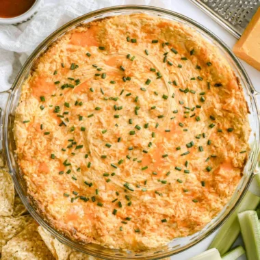 A bowl of Greek Yogurt Buffalo Chicken Dip served with chips and celery