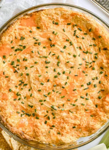 A bowl of Greek Yogurt Buffalo Chicken Dip served with chips and celery