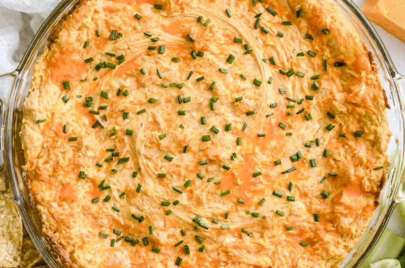 A bowl of Greek Yogurt Buffalo Chicken Dip served with chips and celery