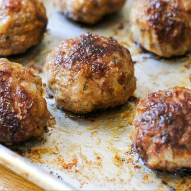 Delicious homemade meatballs served with marinara sauce and spaghetti.