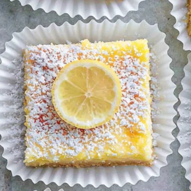 Deliciously sweet Lemon Cream Cheese Bars topped with a lemon zest.