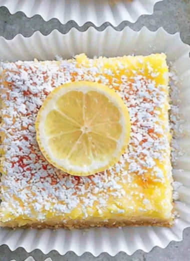 Deliciously sweet Lemon Cream Cheese Bars topped with a lemon zest.