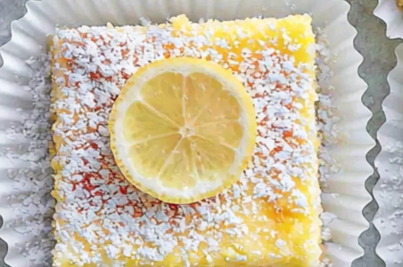 Deliciously sweet Lemon Cream Cheese Bars topped with a lemon zest.