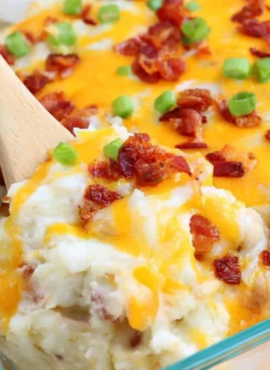 Loaded baked potato casserole topped with cheese and green onions