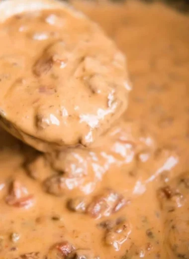 Slow Cooker Queso Dip in a serving bowl with tortilla chips