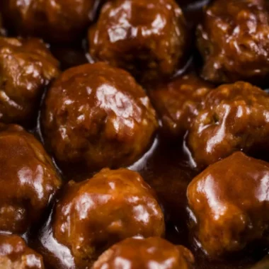 Delicious slow cooker Salisbury steak meatballs served on a plate with gravy.