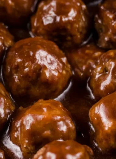 Delicious slow cooker Salisbury steak meatballs served on a plate with gravy.