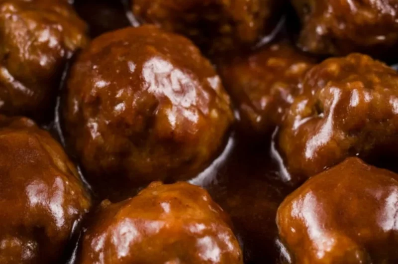 Delicious slow cooker Salisbury steak meatballs served on a plate with gravy.