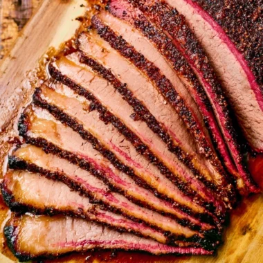 Delicious smoked pellet grill brisket displayed on a wooden board