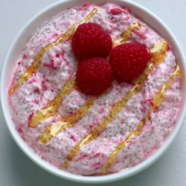 A bowl of yogurt chia pudding topped with fresh fruits and nuts