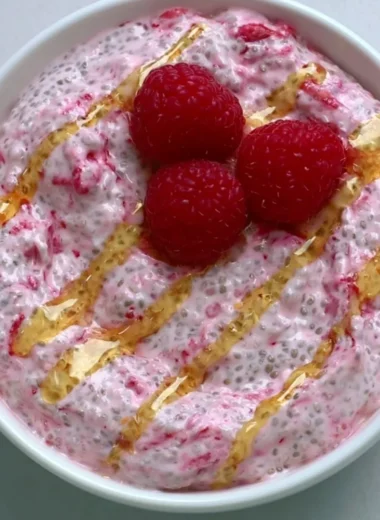 A bowl of yogurt chia pudding topped with fresh fruits and nuts