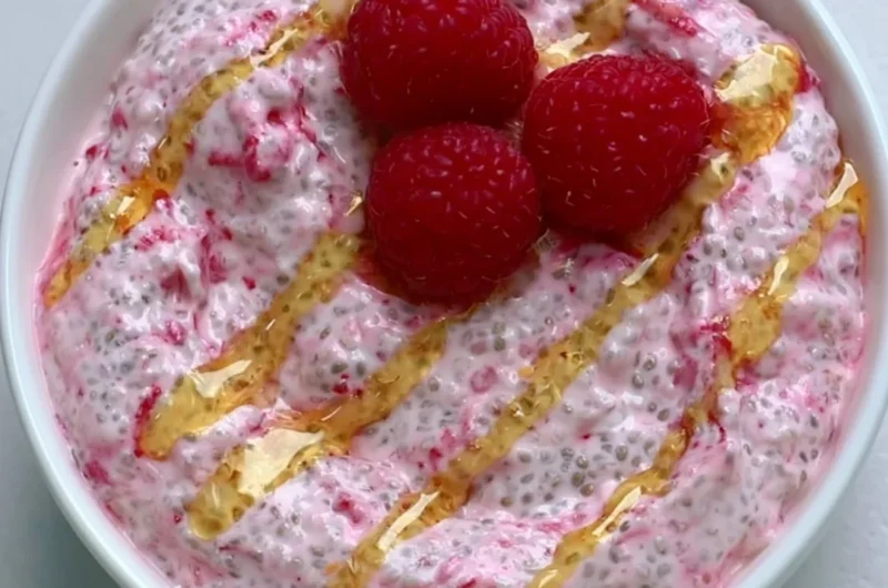 A bowl of yogurt chia pudding topped with fresh fruits and nuts