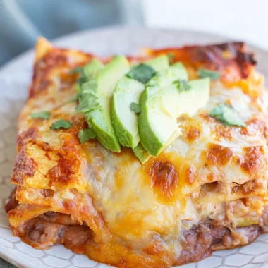 Delicious bean and cheese enchilada casserole served in a colorful dish