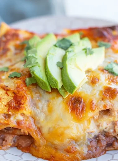 Delicious bean and cheese enchilada casserole served in a colorful dish