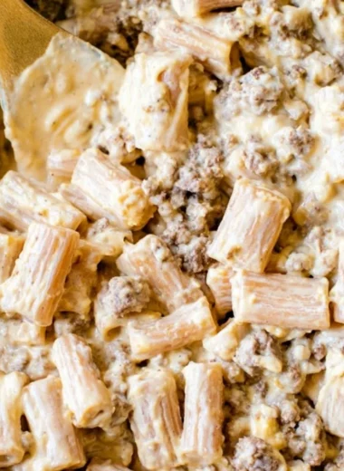 Delicious cheeseburger pasta skillet topped with cheese and garnished with parsley