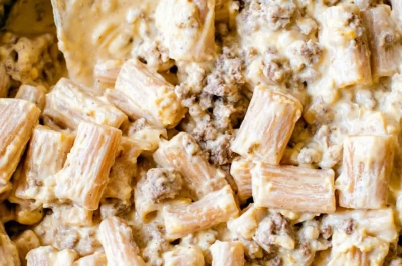 Delicious cheeseburger pasta skillet topped with cheese and garnished with parsley