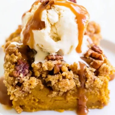 Delicious Pumpkin Pie Crunch Cake topped with crunchy pecans and whipped cream