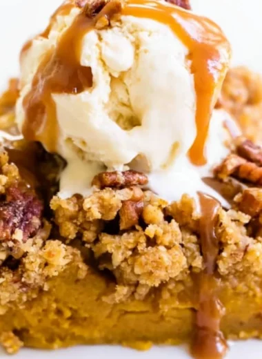 Delicious Pumpkin Pie Crunch Cake topped with crunchy pecans and whipped cream