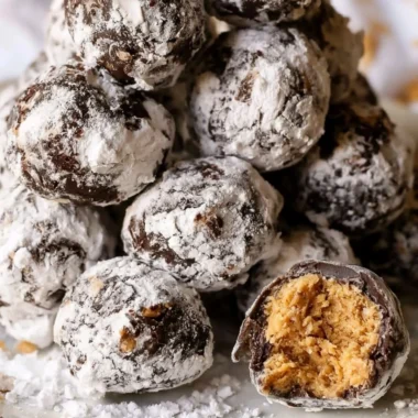 Delicious Puppy Chow Truffles topped with chocolate and nuts