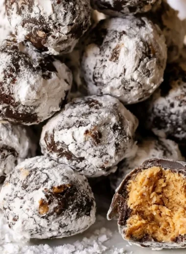 Delicious Puppy Chow Truffles topped with chocolate and nuts