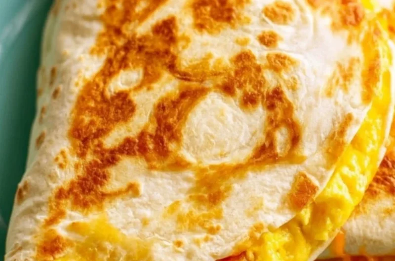 Delicious breakfast quesadilla filled with eggs, cheese, and veggies