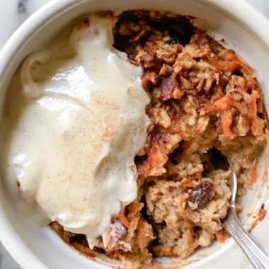 Delicious carrot cake baked oatmeal topped with cream cheese frosting