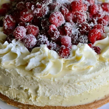 Delicious Christmas cheesecake topped with cranberry jam and white chocolate mousse