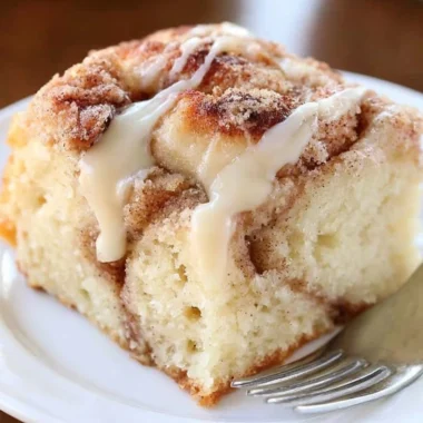 Delicious cinnamon roll coffee cake topped with icing and cinnamon swirl