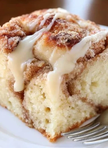 Delicious cinnamon roll coffee cake topped with icing and cinnamon swirl