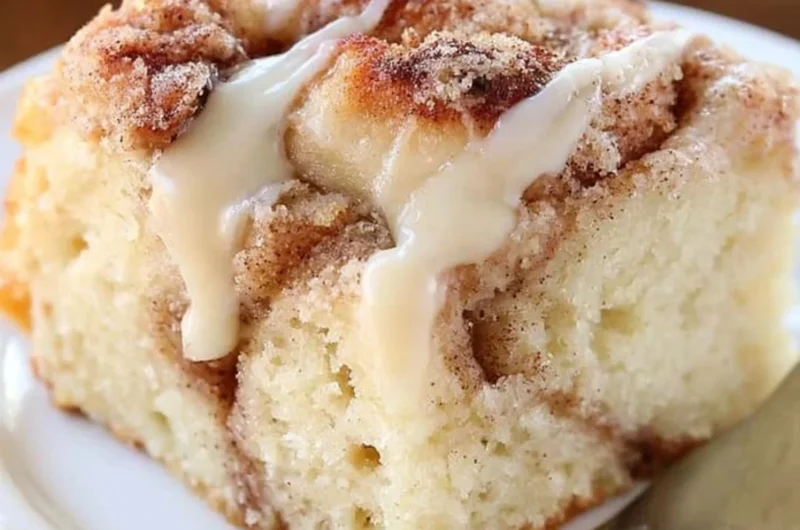 Delicious cinnamon roll coffee cake topped with icing and cinnamon swirl