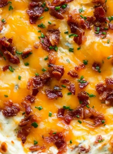 Cream cheese dip with bacon and cheddar served in a bowl