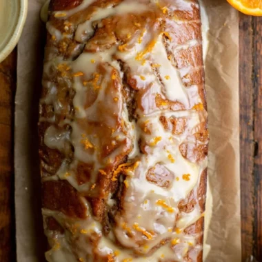 Loaf of easy gingerbread bread topped with spices and decorative icing