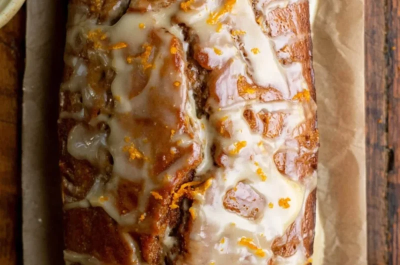 Loaf of easy gingerbread bread topped with spices and decorative icing