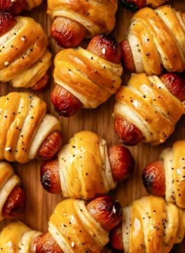 Delicious glazed pigs in a blanket served on a platter
