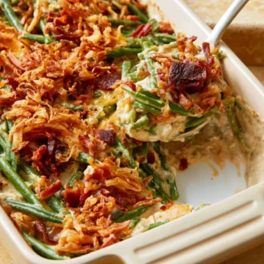 Parmesan Bacon Green Bean Casserole topped with crispy bacon and cheese