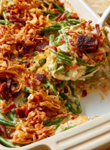Parmesan Bacon Green Bean Casserole topped with crispy bacon and cheese