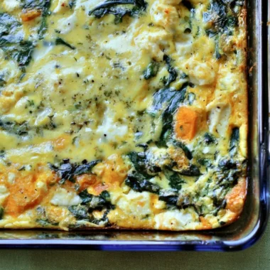 Spinach and Feta Egg Bake served in a baking dish, garnished with herbs