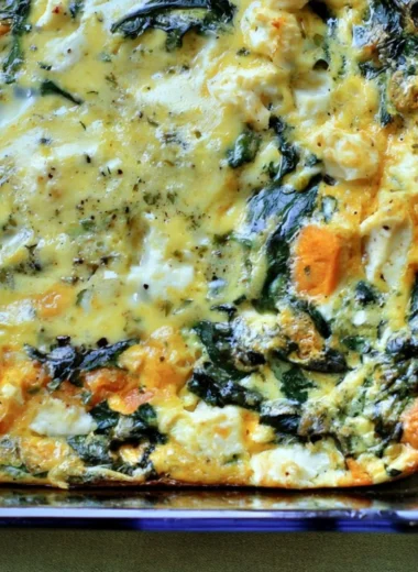 Spinach and Feta Egg Bake served in a baking dish, garnished with herbs